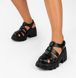 Sandale Spartiate Femme à Talon Épais Noir, style gladiateur, avec brides multiples, bride réglable à la cheville, semelle plateforme crantée et talon bloc épais