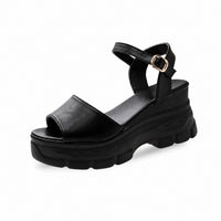 Sandales Plateformes Avec Fermeture À Boucle noires avec large bride avant, bride réglable à la cheville, semelle plateforme épaisse et crantée, et design moderne pour un style urbain et confortable.